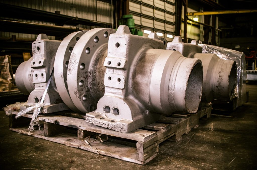 Large orifice fitting bodies on pallets at FAB Industries