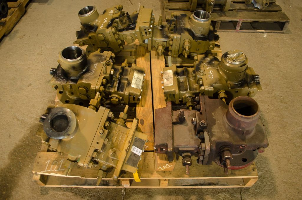 Used orifice fittings awaiting repair at FAB Industries
