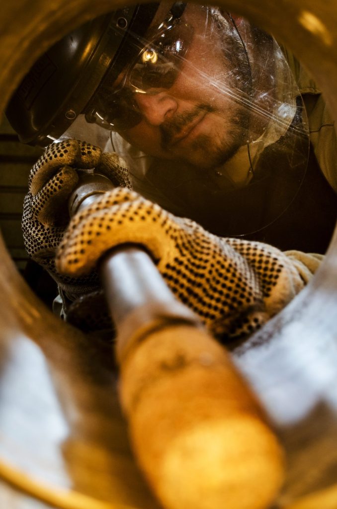 FAB technician working inside a large fitting bore