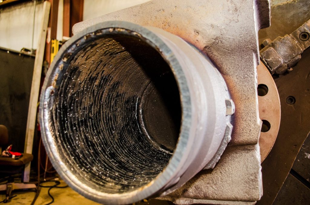 Weld overlay inside an orifice fitting bore