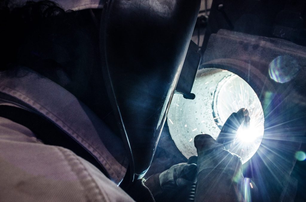 Welder at work in the FAB Industries shop