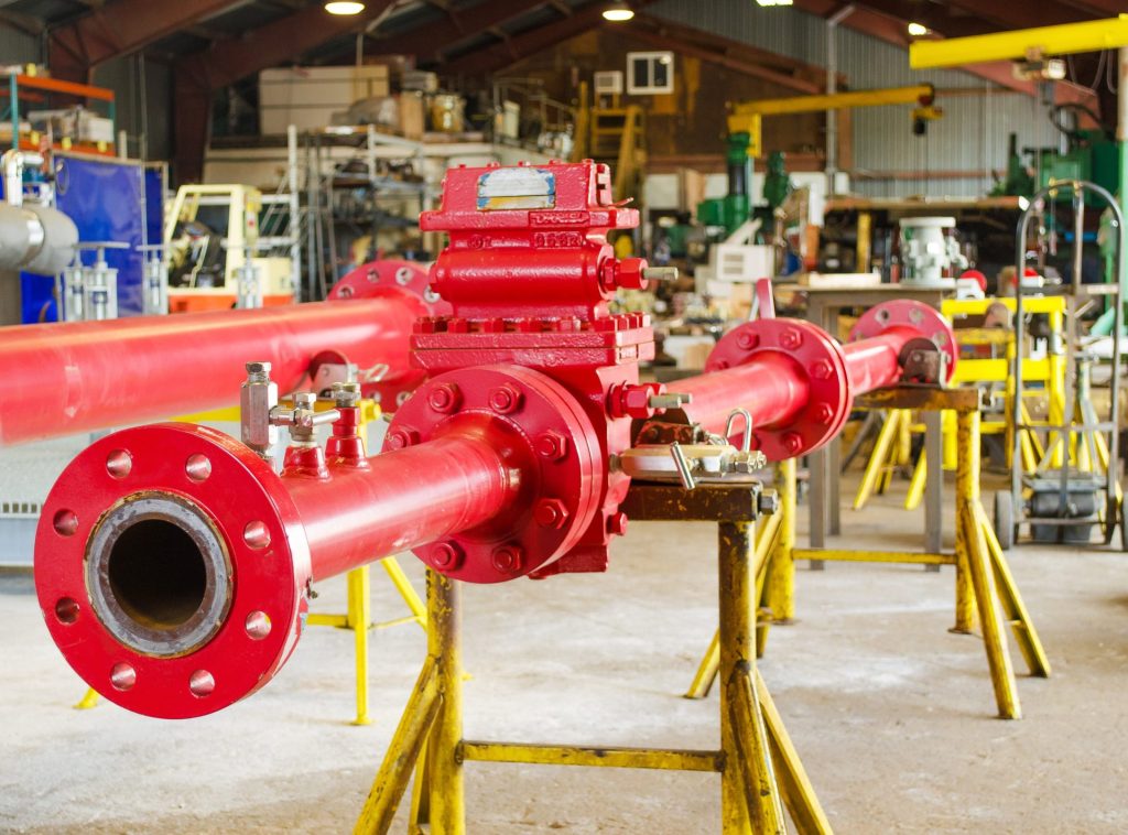 Red orifice meter run on stands in the FAB shop